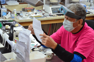 Quality dental lab - dental laboratory technician reading a prescription slip