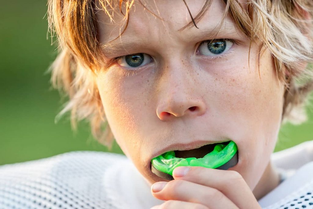 How to choose mouthguards - young football player wearing a mouthguard
