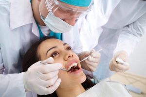 Dentist working on patient's teeth. Dental ethics