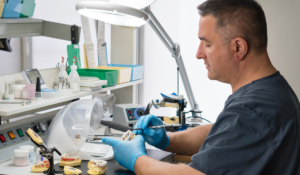 A dental technician creating a dental device at a dental lab. Dentists and dental labs working in unison